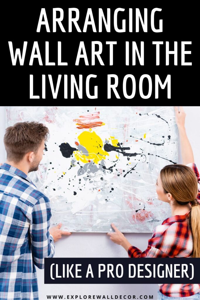 woman and man hanging painting; text that reads: arranging wall art in the living room (like a pro designer)