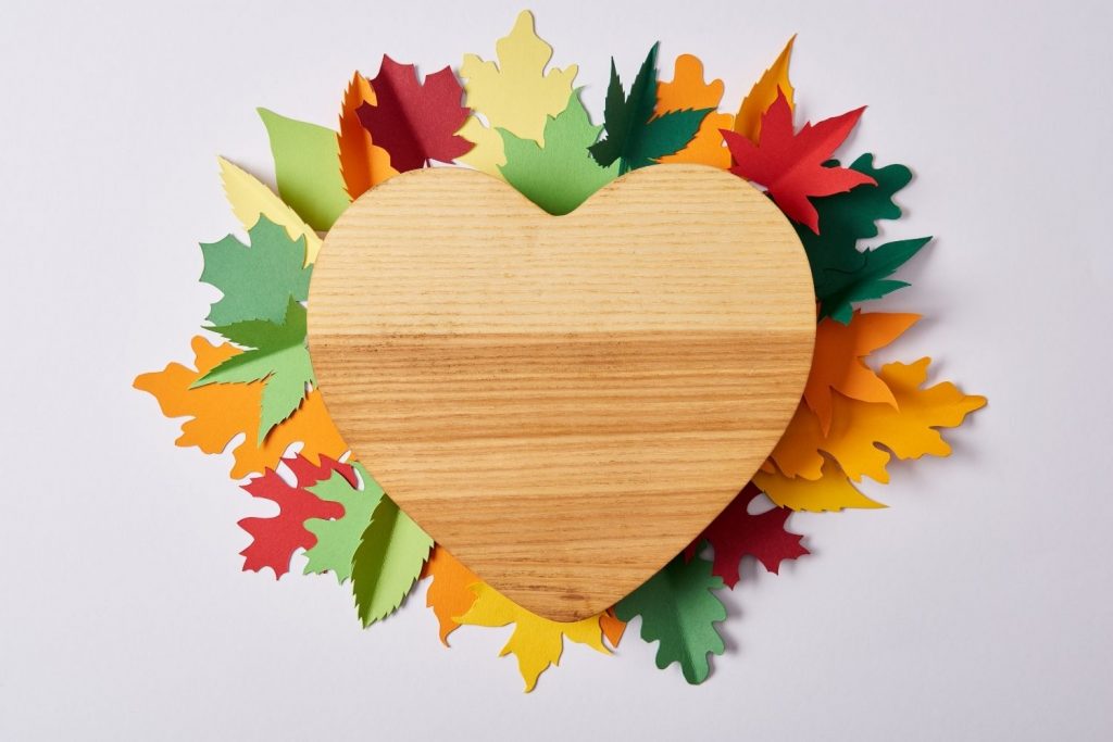 wood heart with paper leaves