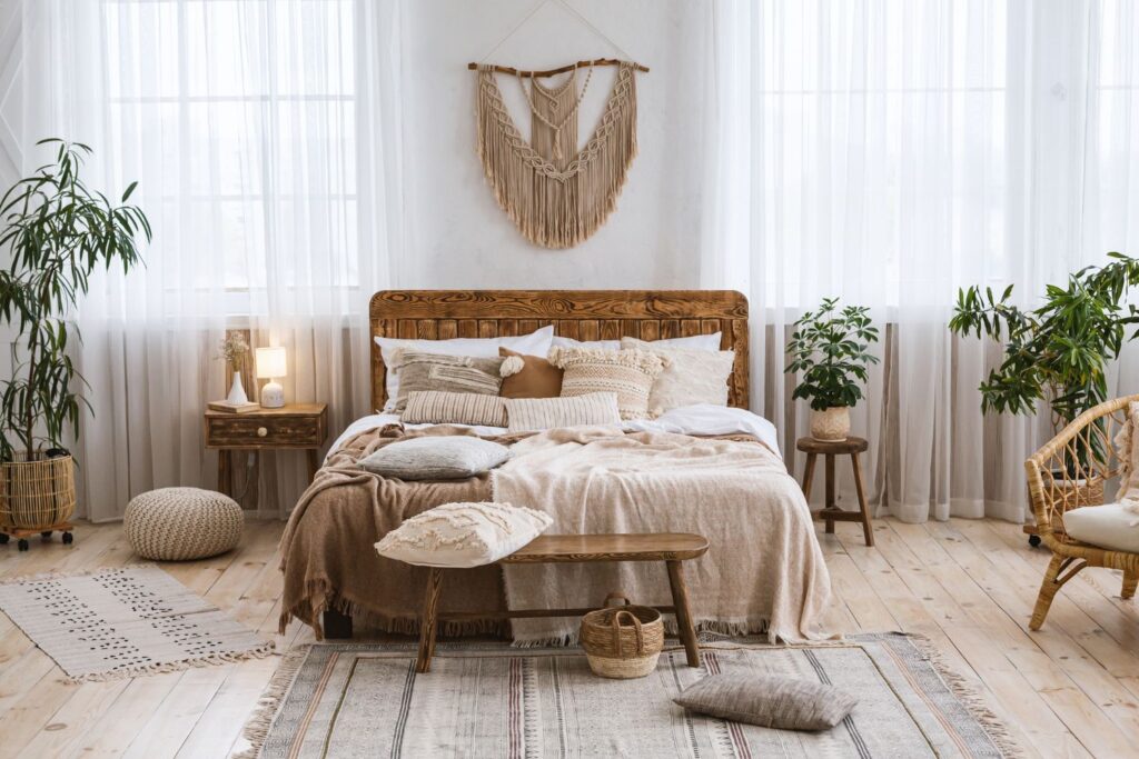 earthy boho bedroom aesthetic with macrame wall hanging, neutral colors, and sheer curtains