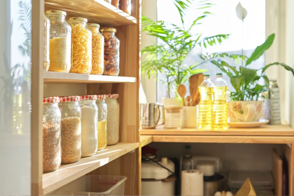 cottagecore kitchen with glass jars displayed on open shelving